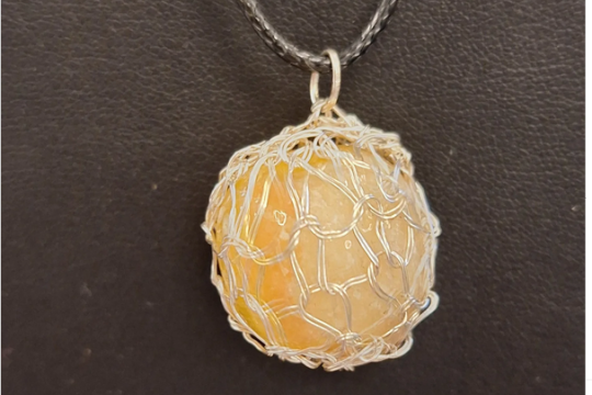 calcite pendant with knitted wire surround